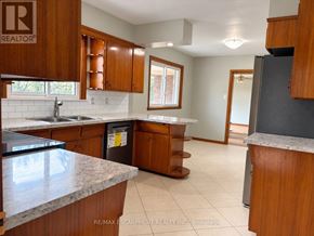 West Lincoln (Bismark/Wellandport) apartment for rent - A kitchen with wooden cabinets and a granite countertop.
