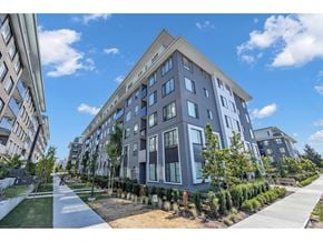 Surrey apartment for rent - A modern apartment building with a well-maintained lawn in front.