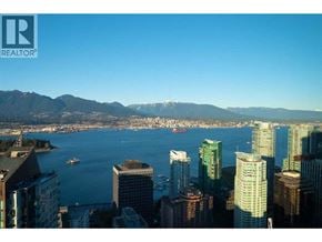 Vancouver apartment for rent - A cityscape with a body of water and mountains in the background.