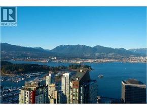 Vancouver apartment for rent - A cityscape with a body of water and mountains in the background.