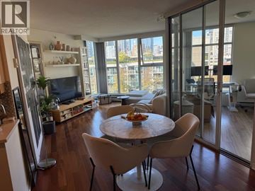 Vancouver apartment for rent - A dining room with a table and chairs in the foreground and a kitchen area in the background.