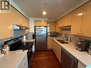 Vancouver apartment for rent - A kitchen with wooden cabinets and a stainless steel refrigerator.