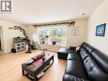 North Vancouver apartment for rent - A living room with a black leather couch and a coffee table.