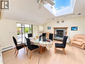 North Vancouver apartment for rent - A living room with a table and chairs and a fireplace.