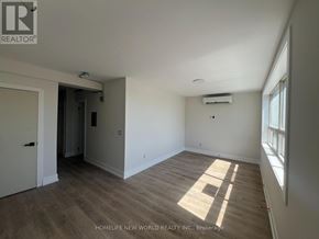 Toronto (Mimico) condo for rent - A room with wooden flooring and a window on the right side.