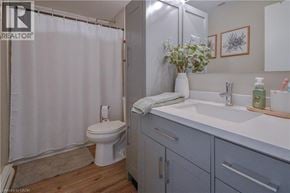 Cambridge townhouse for rent - A bathroom with a white toilet, a white sink, and a white shower curtain.