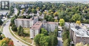 Guelph condo for rent - A bird's eye view of a residential area with apartment buildings and trees.