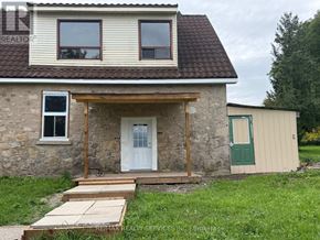 Erin apartment for rent - A stone house with a white door and a green door on the side.
