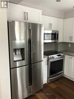 Richmond Hill (Crosby) apartment for rent - A stainless steel refrigerator and oven in a kitchen.