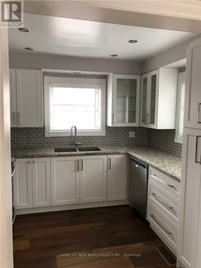 Richmond Hill (Crosby) apartment for rent - A kitchen with white cabinets and a granite countertop.