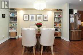 Oakville (Ga Glen Abbey) condo for rent - A dining room with a table and chairs and a chandelier.