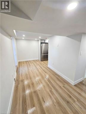 Hamilton apartment for rent - A room with wooden flooring and a refrigerator in the corner.
