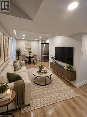 Hamilton apartment for rent - A modern living room with a grey couch, a coffee table, and a flat screen TV.