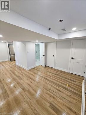 Hamilton apartment for rent - A room with wooden flooring and white walls.