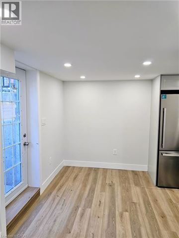 Hamilton apartment for rent - A kitchen with a refrigerator and a wooden floor.