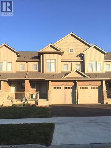 Kitchener townhouse for rent - A large house with a garage is shown in the image.