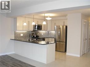 Kitchener townhouse for rent - A modern kitchen with a black countertop and stainless steel appliances.