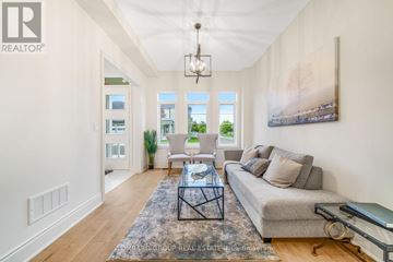 Oakville (Go Glenorchy) apartment for rent - A well-lit living room with a grey sofa and a glass coffee table.