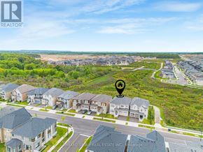 Oakville (Go Glenorchy) apartment for rent - A bird's eye view of a residential area with houses and greenery.