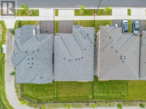 Oakville (Go Glenorchy) apartment for rent - An aerial view of a residential area with houses and cars.