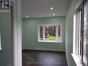 Toronto (Woburn) apartment for rent - A room with a window showing trees outside.