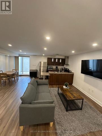 Richmond Hill (Jefferson) apartment for rent - A modern living room with a grey sofa and a wooden coffee table.