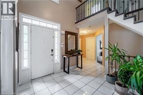 Ancaster apartment for rent - A foyer with a white tile floor and a staircase.