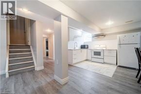 Ancaster apartment for rent - A well-lit kitchen with a refrigerator, microwave, and oven.