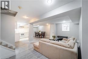 Ancaster apartment for rent - A living room with a couch, chairs, and a dining table.