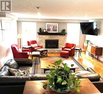 Toronto (Cliffcrest) apartment for rent - A living room with a fireplace and a TV mounted on the wall.