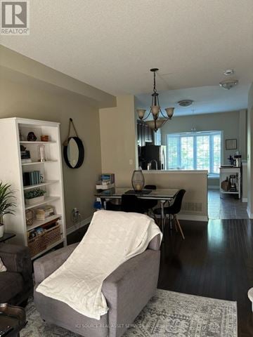 Burlington (Appleby) townhouse for rent - A living room with a grey couch and a white blanket on it.