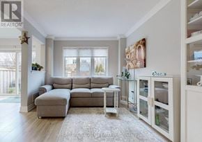 Bradford West Gwillimbury (Bradford) townhouse for rent - A living room with a grey sofa and a glass table.