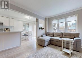 Bradford West Gwillimbury (Bradford) townhouse for rent - A living room with a grey couch and a white table.