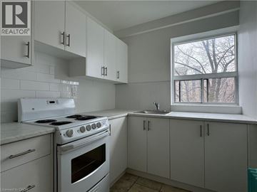 Hamilton apartment for rent - A kitchen with white appliances and cabinets.