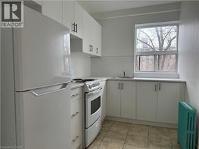 Hamilton apartment for rent - A kitchen with white appliances and cabinets.