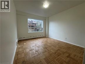 Hamilton apartment for rent - Empty room with wooden flooring and a window.