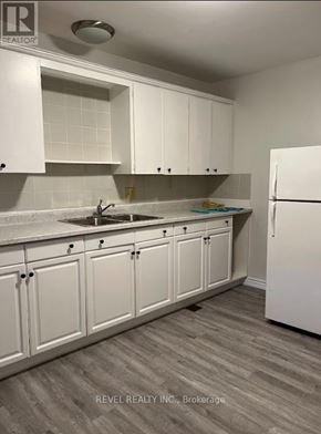 Grimsby (Grimsby East) townhouse for rent - A kitchen with white cabinets and a white refrigerator.