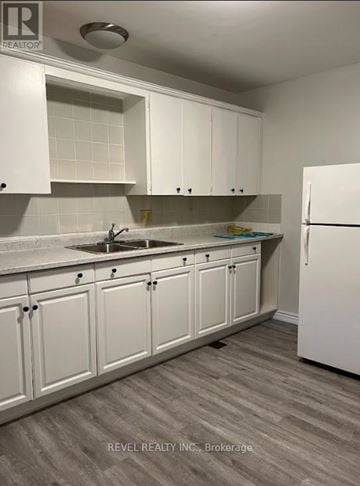 Grimsby (Grimsby East) townhouse for rent - A kitchen with white cabinets and a white refrigerator.