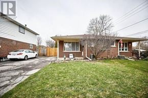 Oshawa (Eastdale) apartment for rent - A house with a white car parked in front.