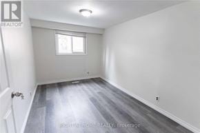 Oshawa (Eastdale) apartment for rent - A room with a door, a window, and a wall with a logo.