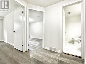 Oshawa (Eastdale) apartment for rent - A white bathroom with a toilet and a sink.