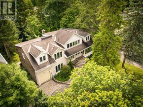 Ottawa apartment for rent - A large house with a brown roof surrounded by trees.