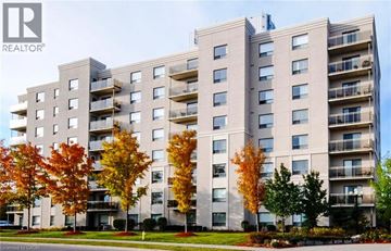 Waterloo apartment for rent - A large apartment building with balconies and trees in front.