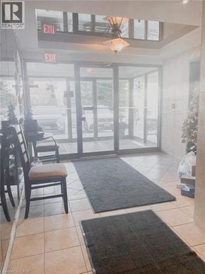 Waterloo apartment for rent - A realtor office with a chair and a table.