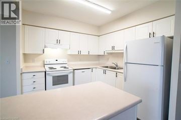 Waterloo apartment for rent - A kitchen with white appliances and cabinets.