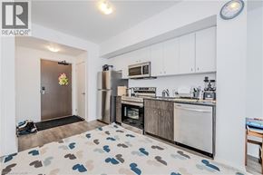 Waterloo condo for rent - A kitchen with a refrigerator, oven, and microwave.