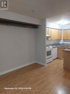 Mississauga (City Centre) condo for rent - A kitchen with wooden floors and white walls.