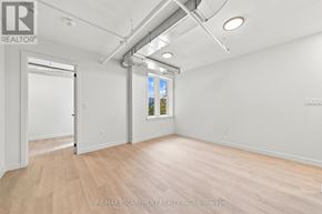 Hamilton (Corktown) multi-family for rent - A room with a door and a window with a view of trees outside.