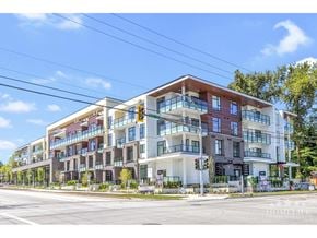 Surrey apartment for rent - A modern multi-story apartment building with balconies and large windows.