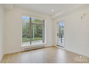 Surrey apartment for rent - A room with a large window and wooden flooring.
